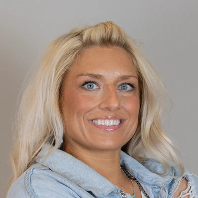 Bridgett Erickson, a massage therapist at Health & Wellness Center Edina, is pictured smiling warmly